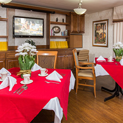 Linen tablecloths and soft seating at the dining hall of Bay Crest Care Center